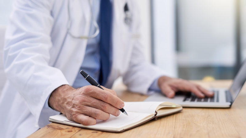Doctor,,Writing,And,Hands,Of,Notes,With,Computer,And,Medical