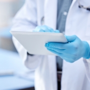 Doctor,,Hands,And,Gloves,With,Digital,Tablet,For,Record,Keeping