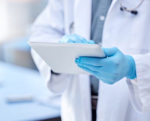 Doctor,,Hands,And,Gloves,With,Digital,Tablet,For,Record,Keeping