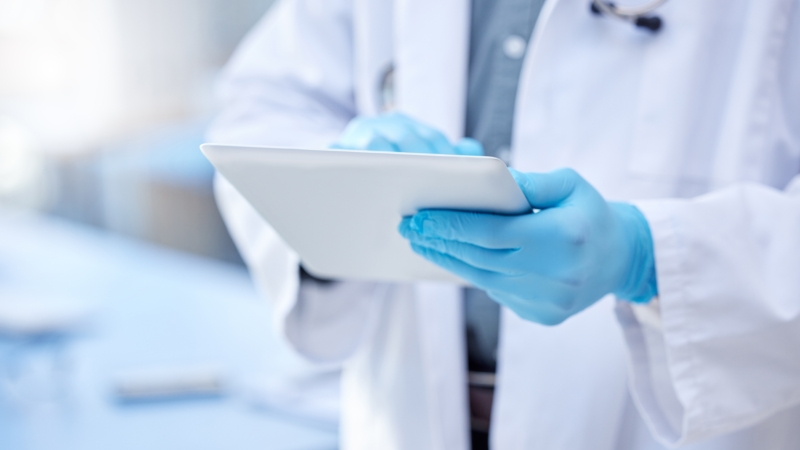 Doctor,,Hands,And,Gloves,With,Digital,Tablet,For,Record,Keeping