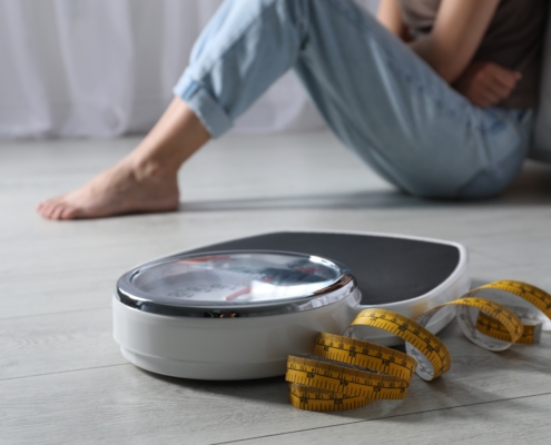 Eating,Disorder.,Sad,Woman,Sitting,Near,Scale,And,Measuring,Tape