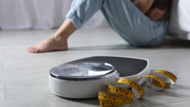 Eating,Disorder.,Sad,Woman,Sitting,Near,Scale,And,Measuring,Tape