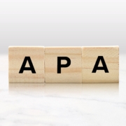 Wooden,Tiles,Spelling,Out,Apa,Atop,A,Lovely,Marble,Tabletop.