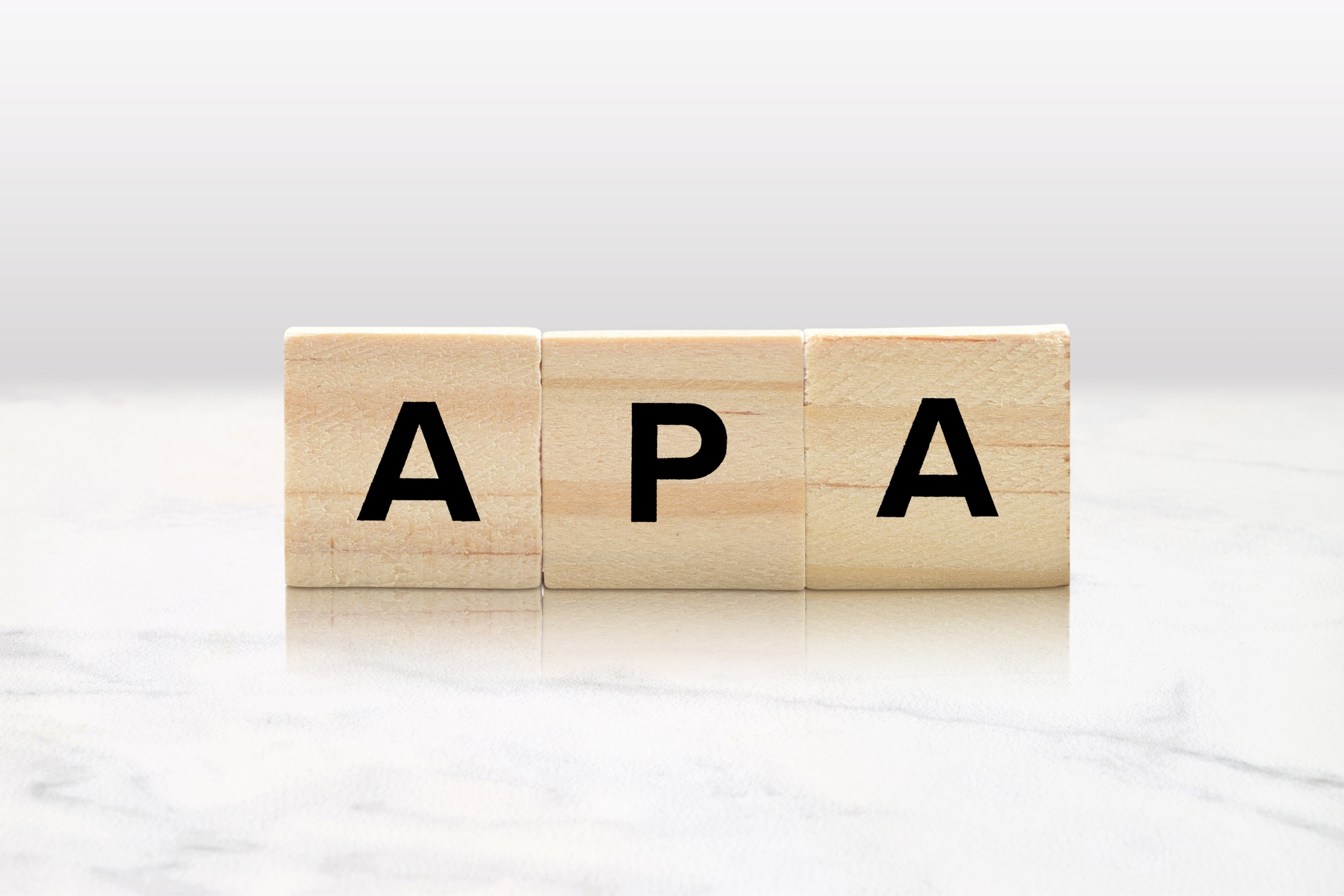 Wooden,Tiles,Spelling,Out,Apa,Atop,A,Lovely,Marble,Tabletop.