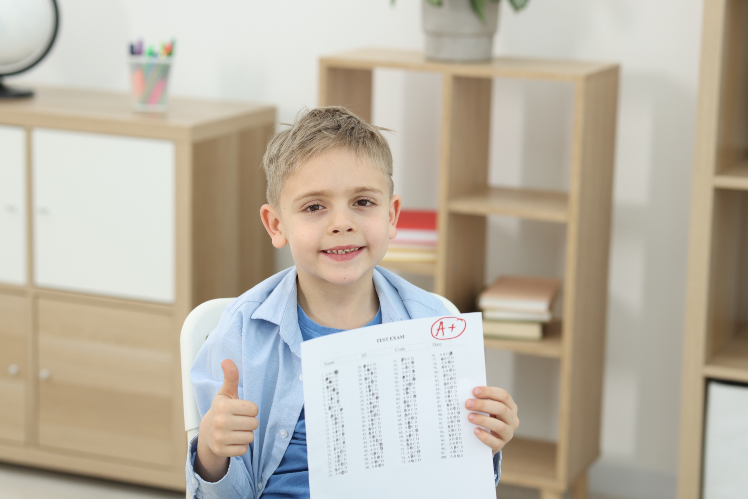 School,Grade.,Happy,Boy,Holding,Answer,Sheet,With,Letter,A