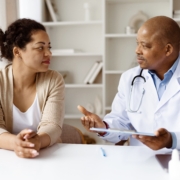 African,American,Doctor,Explaining,Treatment,Options,To,Black,Woman,Patient