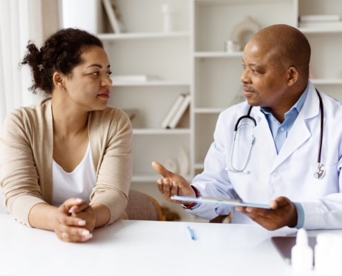 African,American,Doctor,Explaining,Treatment,Options,To,Black,Woman,Patient