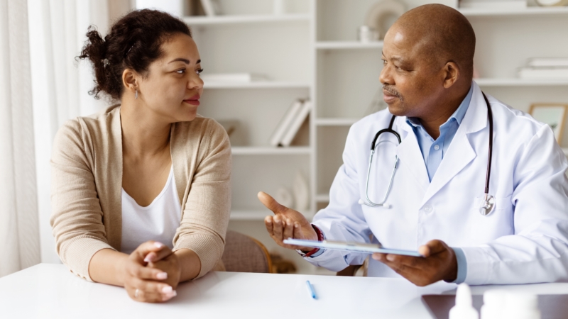African,American,Doctor,Explaining,Treatment,Options,To,Black,Woman,Patient