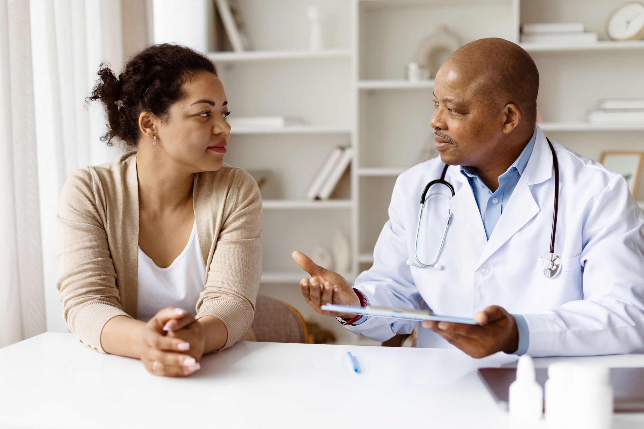 African,American,Doctor,Explaining,Treatment,Options,To,Black,Woman,Patient