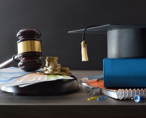 Education,Cost,Law,Concept,With,Money,On,A,Wooden,Base