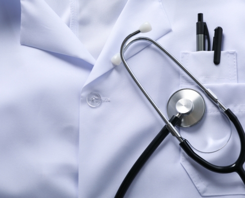 Close-up,Of,White,Doctor,Coat,With,Stethoscope,And,Pens,In