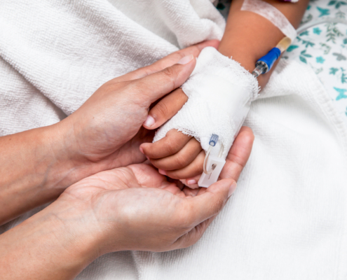 Mother,Holding,Child’s,Hand,Who,Have,Iv,Solution,In,The