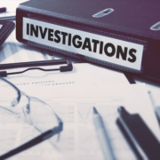 Ring,Binder,With,Inscription,Investigations,On,Background,Of,Working,Table