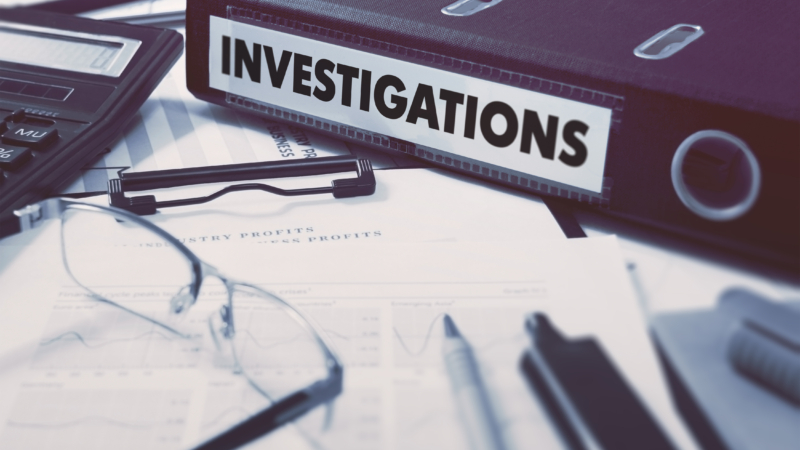 Ring,Binder,With,Inscription,Investigations,On,Background,Of,Working,Table