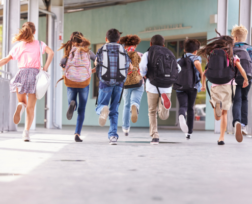 Group,Of,Elementary,School,Kids,Running,At,School,,Back,View