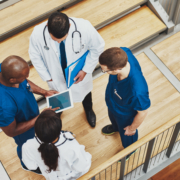 Multiracial,Medical,Team,Having,A,Discussion,As,They,Stand,Grouped