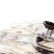 Stethoscope,Laying,On,Stacks,Of,Hundred,Dollar,Bills,With,Narrow