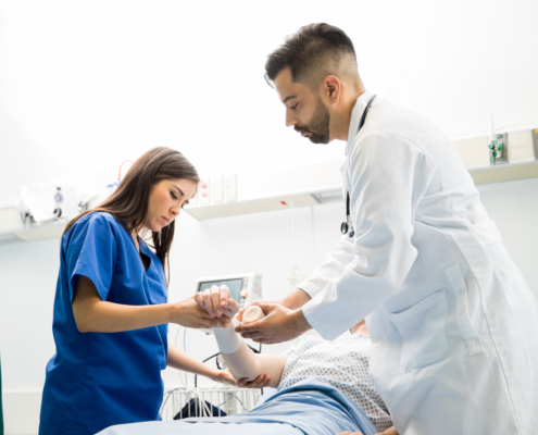 Good,Looking,Doctors,Putting,A,Bandage,On,A,Patient’s,Arm