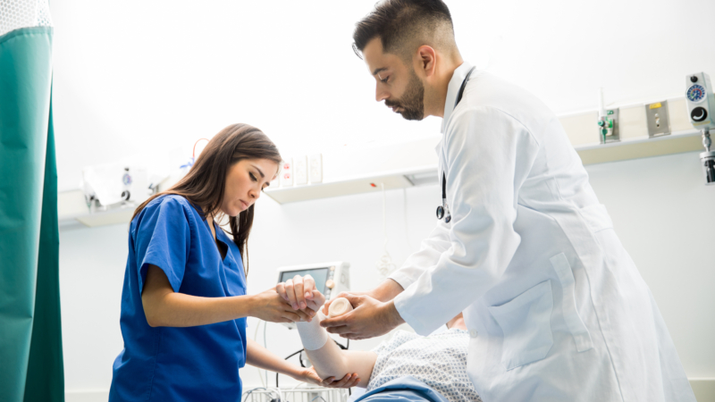 Good,Looking,Doctors,Putting,A,Bandage,On,A,Patient’s,Arm