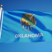Oklahoma,(u.s.,State),Flag,Waving,Against,Clear,Blue,Sky,,Close
