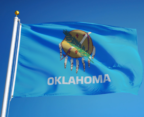 Oklahoma,(u.s.,State),Flag,Waving,Against,Clear,Blue,Sky,,Close