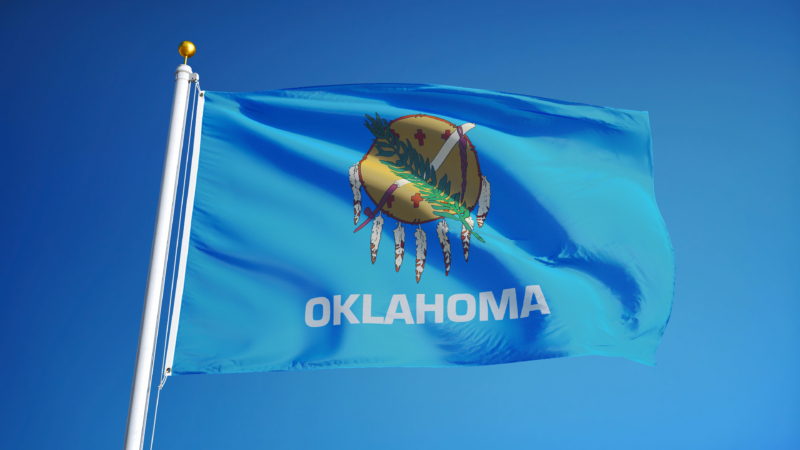 Oklahoma,(u.s.,State),Flag,Waving,Against,Clear,Blue,Sky,,Close