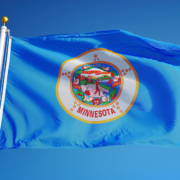 Minnesota,(u.s.,State),Flag,Waving,Against,Clear,Blue,Sky,,Close