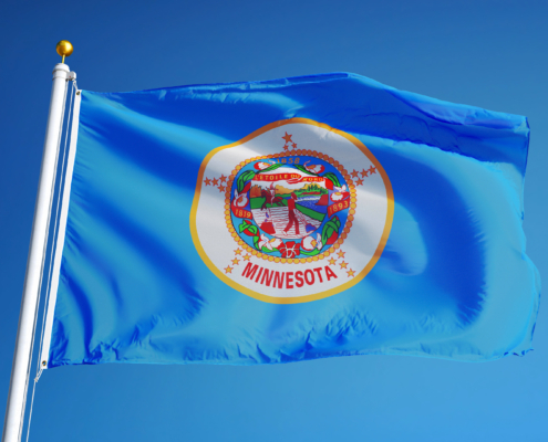 Minnesota,(u.s.,State),Flag,Waving,Against,Clear,Blue,Sky,,Close