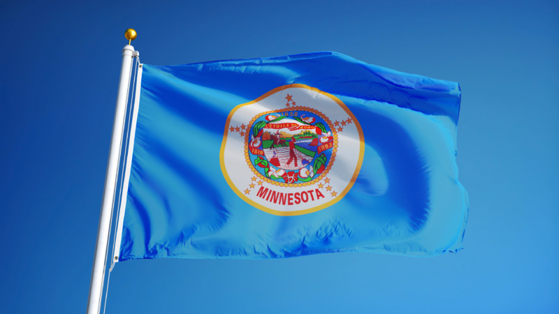 Minnesota,(u.s.,State),Flag,Waving,Against,Clear,Blue,Sky,,Close