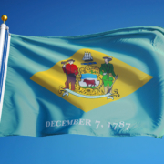 Delaware,(u.s.,State),Flag,Waving,Against,Clear,Blue,Sky,,Close