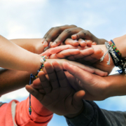 Multiracial,Teenagers,Joining,Hands,Together,In,Cooperation
