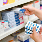 Pharmacist,Holding,Medicine,Box,And,Capsule,Pack,In,Pharmacy,Drugstore.