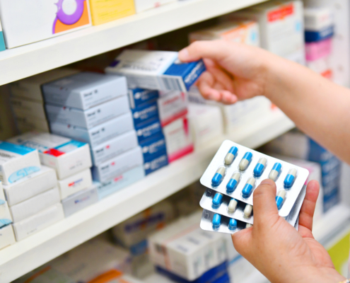 Pharmacist,Holding,Medicine,Box,And,Capsule,Pack,In,Pharmacy,Drugstore.