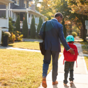 Businessman,Father,Walking,Son,On,Scooter,To,School